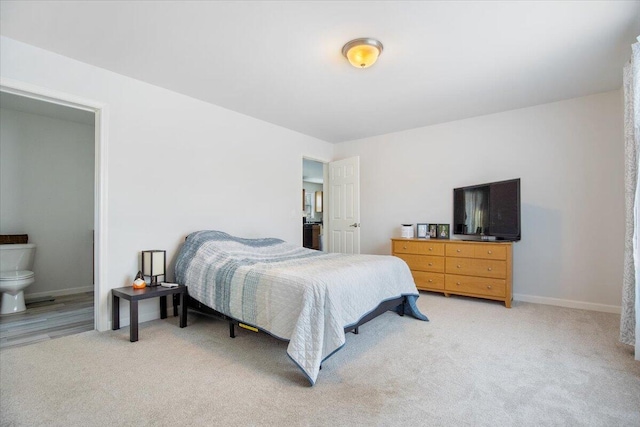 carpeted bedroom with ensuite bath