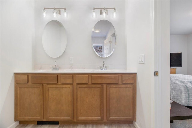 bathroom with hardwood / wood-style floors and vanity