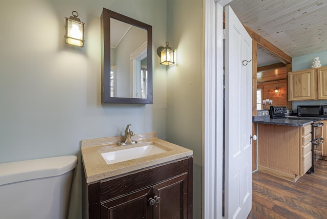 bathroom featuring vanity, hardwood / wood-style flooring, toilet, and wood ceiling