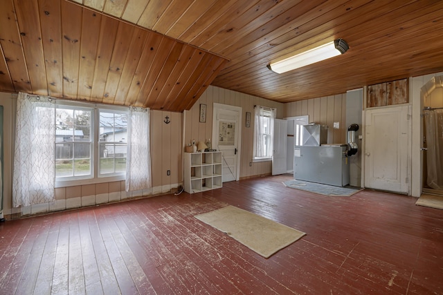 kitchen featuring wood-type flooring, vaulted ceiling, wooden ceiling, and wood walls