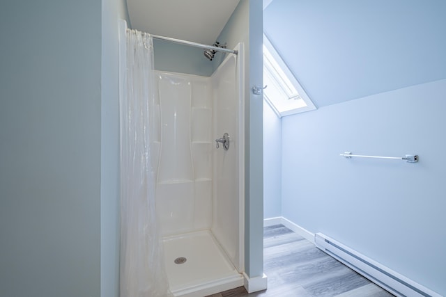 bathroom featuring baseboard heating, curtained shower, and hardwood / wood-style floors