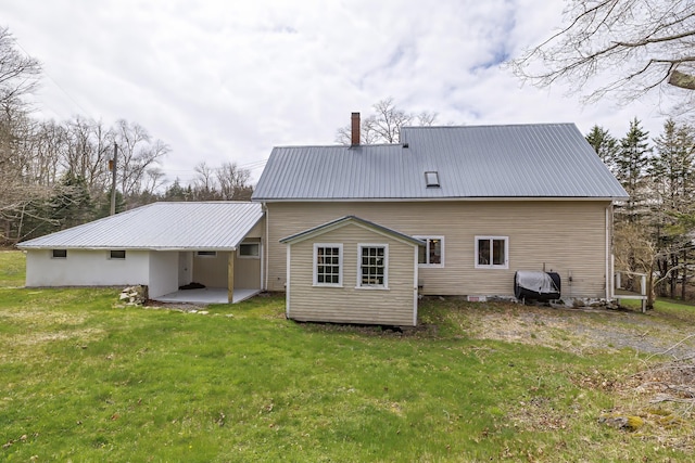 rear view of property featuring a yard and a patio