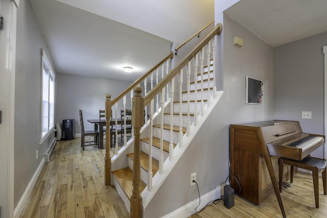 stairs with hardwood / wood-style floors