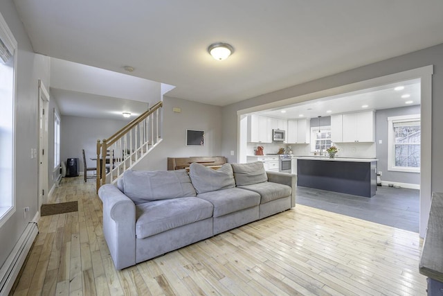 living room featuring light hardwood / wood-style floors and baseboard heating