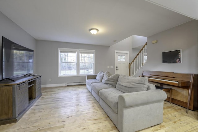 living room featuring light wood-type flooring and a baseboard radiator