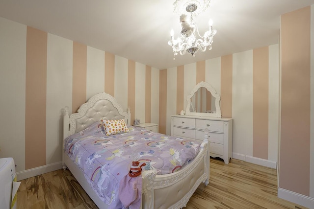 bedroom featuring light hardwood / wood-style flooring and an inviting chandelier