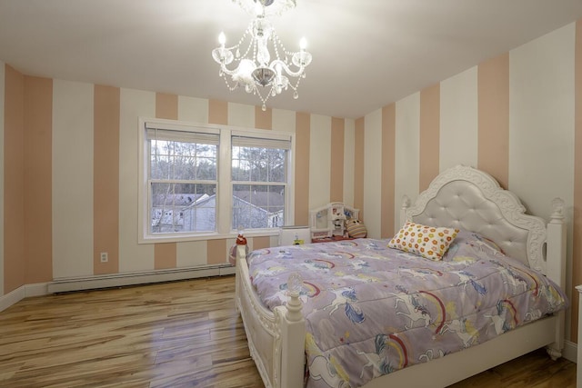 bedroom featuring an inviting chandelier, light hardwood / wood-style flooring, and a baseboard heating unit