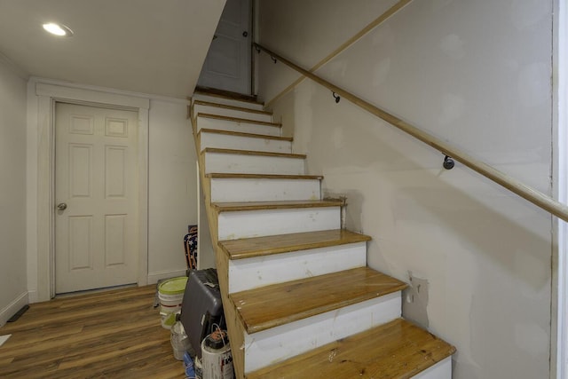 staircase with wood-type flooring