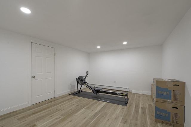 exercise area with light hardwood / wood-style flooring