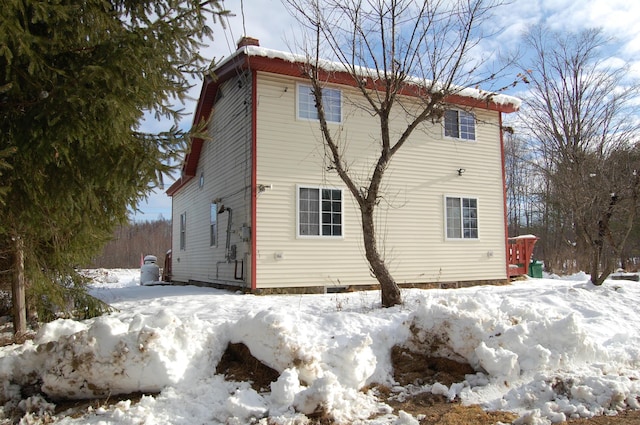 view of snow covered rear of property