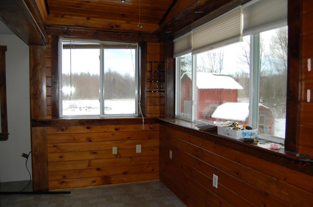 unfurnished sunroom with plenty of natural light and wood ceiling