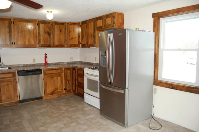 kitchen featuring ceiling fan and stainless steel appliances