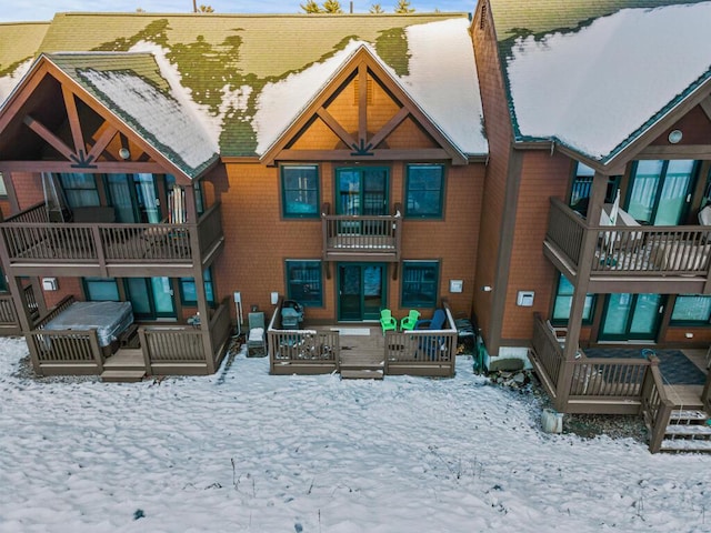 view of snow covered back of property