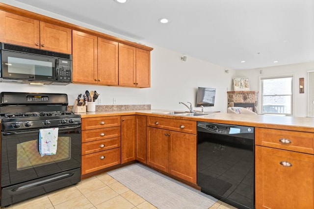 kitchen with light tile patterned flooring, sink, kitchen peninsula, and black appliances