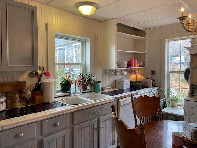 11 Dunton Ave, Rockland, ME 04841 - kitchen featuring a chandelier, gray cabinetry, wooden walls, open shelves, and tile countertops