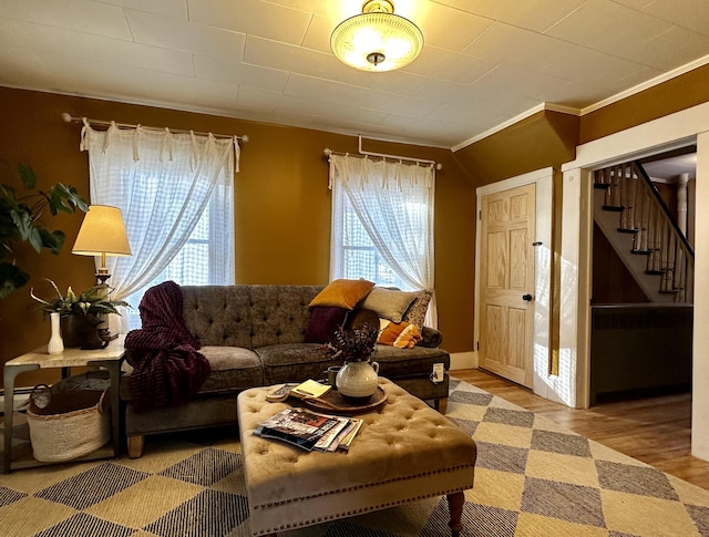 living room with crown molding and hardwood / wood-style flooring