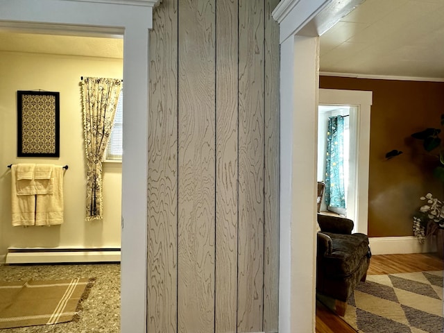 hallway with plenty of natural light and a baseboard heating unit