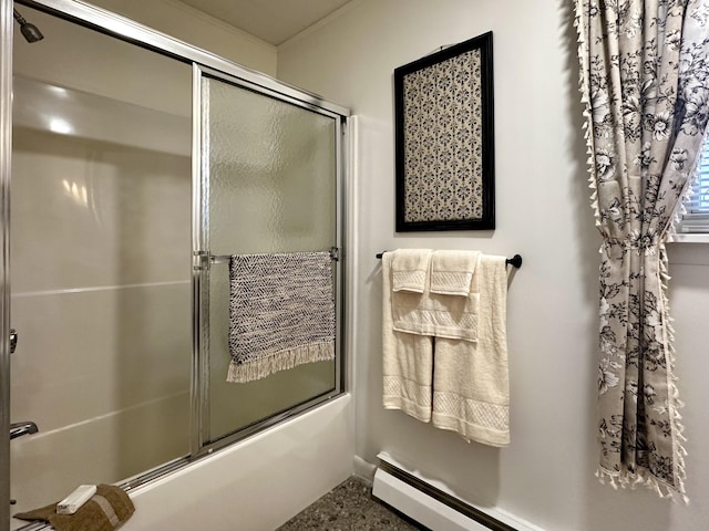 bathroom with a baseboard radiator and combined bath / shower with glass door