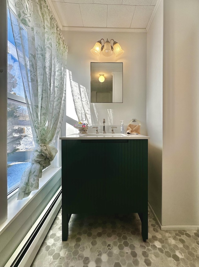 bathroom featuring a baseboard radiator, vanity, and crown molding