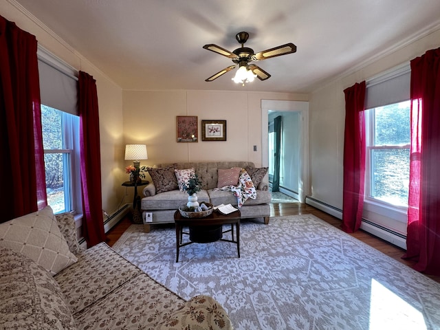 living room with baseboard heating, ceiling fan, ornamental molding, and dark hardwood / wood-style floors