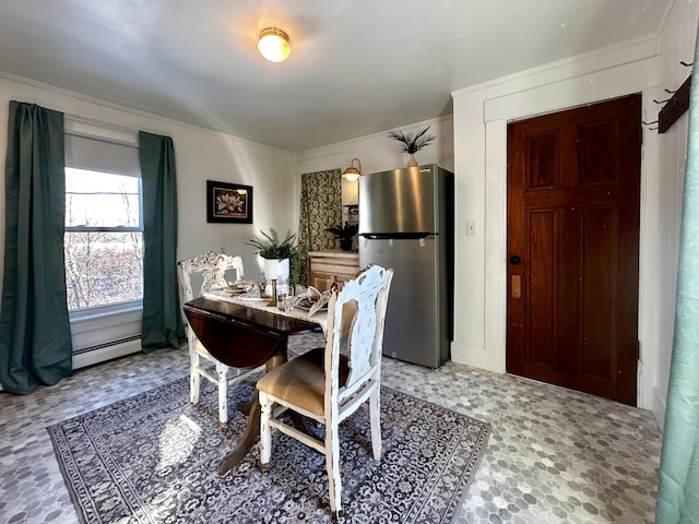 dining space with a baseboard heating unit