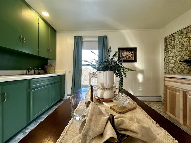 dining area featuring sink, crown molding, and a baseboard radiator