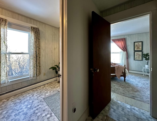 bathroom featuring a baseboard radiator and wooden walls