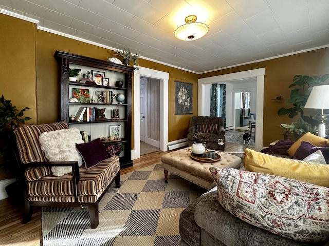 living room featuring hardwood / wood-style floors, crown molding, and a baseboard radiator