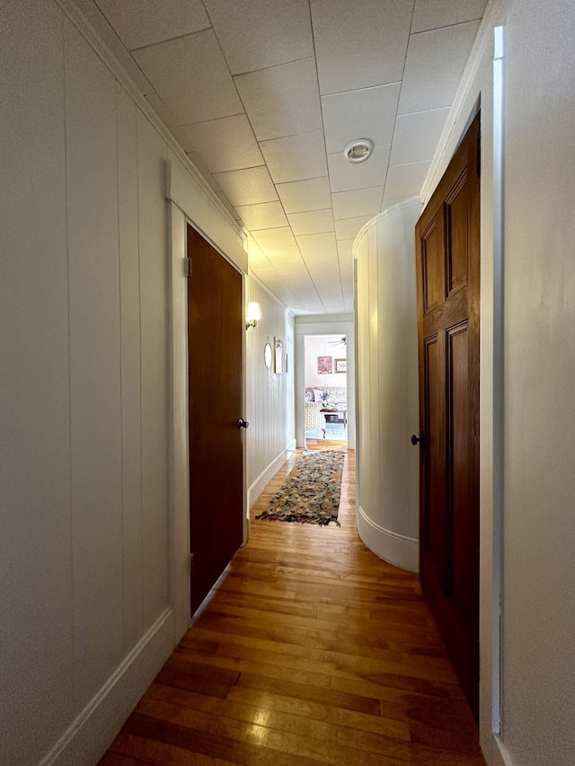 corridor with crown molding and dark hardwood / wood-style floors