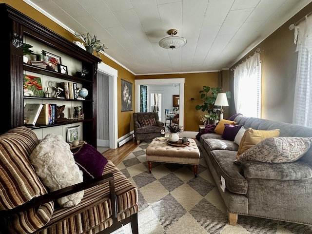 living area with crown molding, a baseboard radiator, and light wood-type flooring