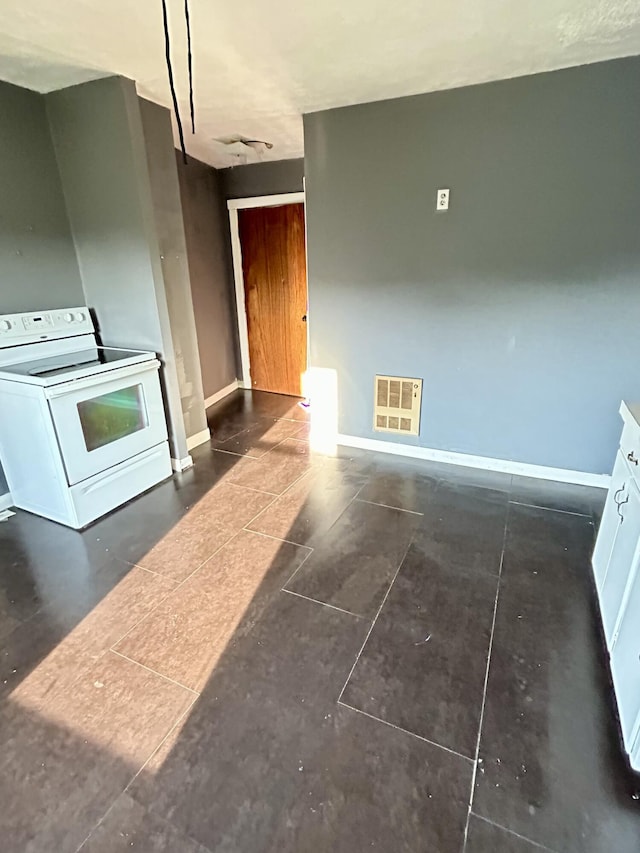 kitchen featuring white cabinets and white electric stove