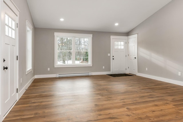 entryway with baseboard heating, dark hardwood / wood-style flooring, and lofted ceiling