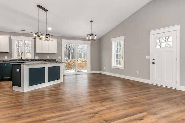 kitchen featuring white cabinets, pendant lighting, and dark wood-type flooring