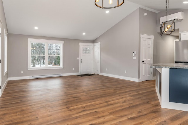 foyer featuring baseboard heating, high vaulted ceiling, a wall unit AC, and dark hardwood / wood-style flooring