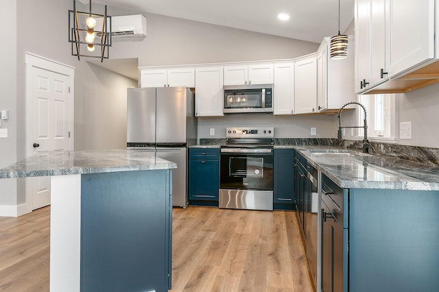 kitchen featuring a center island, blue cabinetry, white cabinets, appliances with stainless steel finishes, and sink