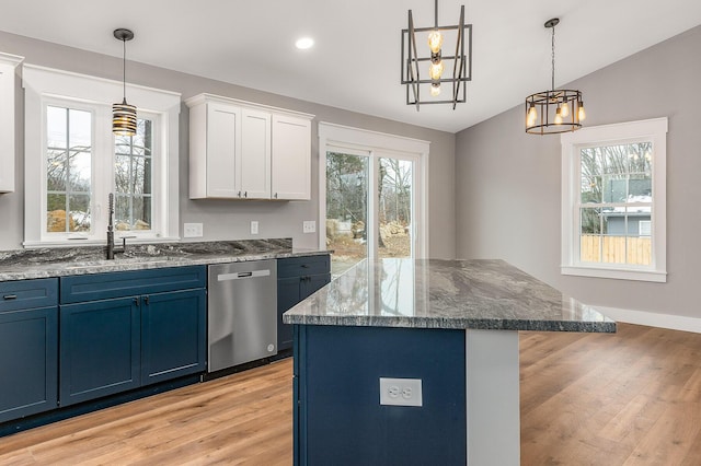 kitchen with blue cabinetry, a center island, a notable chandelier, white cabinetry, and stainless steel dishwasher