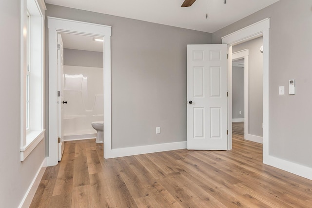 unfurnished bedroom featuring connected bathroom, ceiling fan, and light hardwood / wood-style flooring