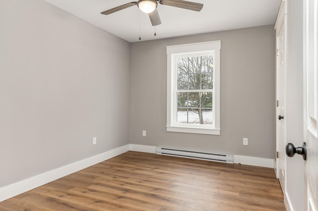 unfurnished room featuring baseboard heating, ceiling fan, and hardwood / wood-style floors