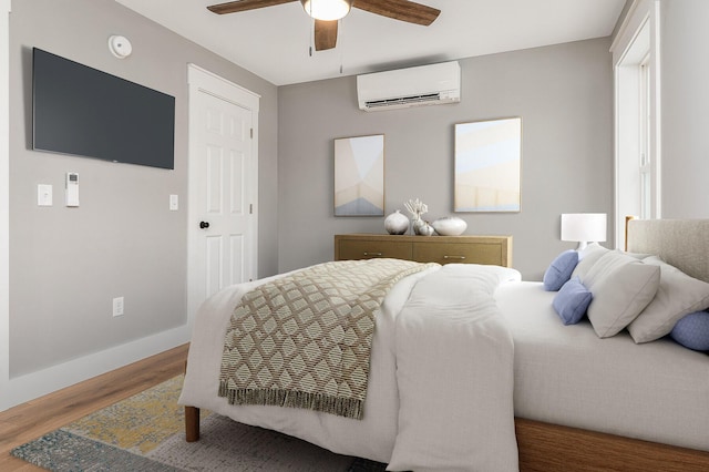 bedroom featuring a wall unit AC, ceiling fan, and hardwood / wood-style flooring