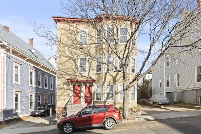 view of front of property with a wall mounted air conditioner