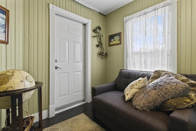 living area featuring hardwood / wood-style floors and ornamental molding