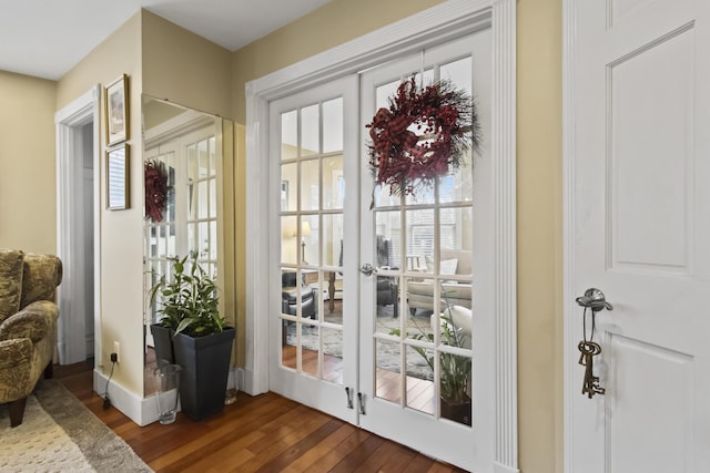 doorway with dark hardwood / wood-style floors and french doors