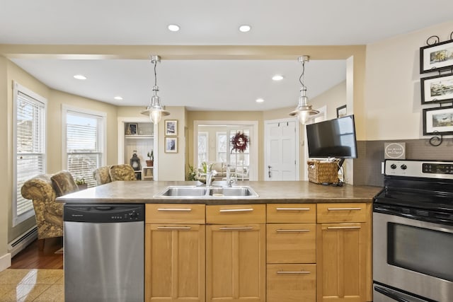 kitchen featuring plenty of natural light, decorative light fixtures, sink, and appliances with stainless steel finishes