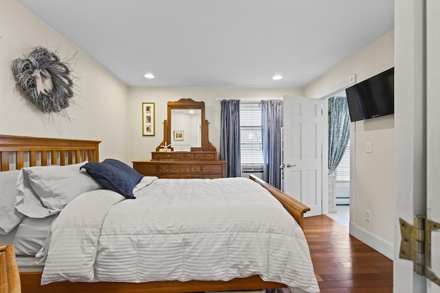 bedroom featuring dark hardwood / wood-style floors and a baseboard radiator