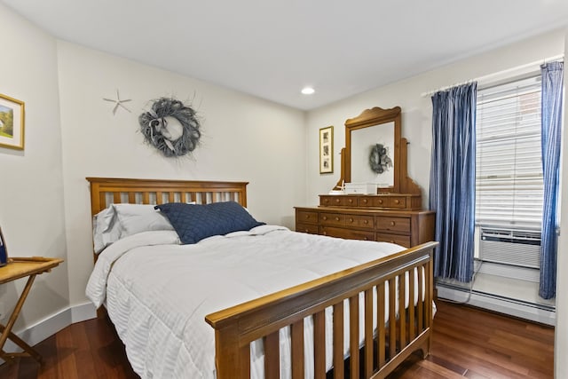 bedroom featuring dark wood-type flooring and a baseboard heating unit