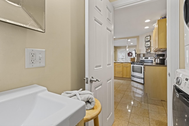 kitchen featuring stainless steel electric stove, electric range oven, and sink