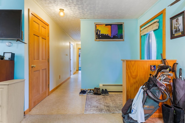 hallway featuring a textured ceiling, crown molding, and a baseboard heating unit