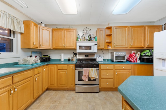 kitchen with sink, white appliances, and crown molding