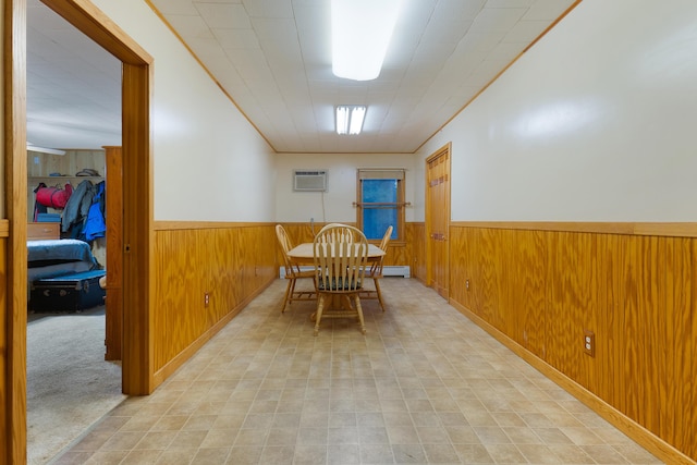 dining room with light colored carpet, a wall unit AC, and wood walls