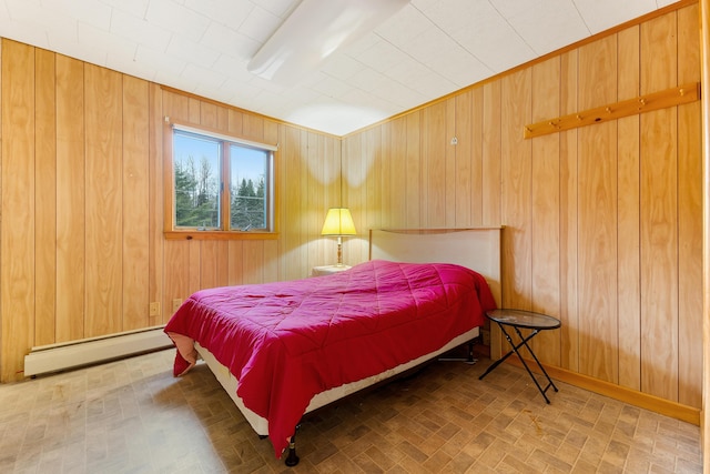 bedroom with baseboard heating and wooden walls